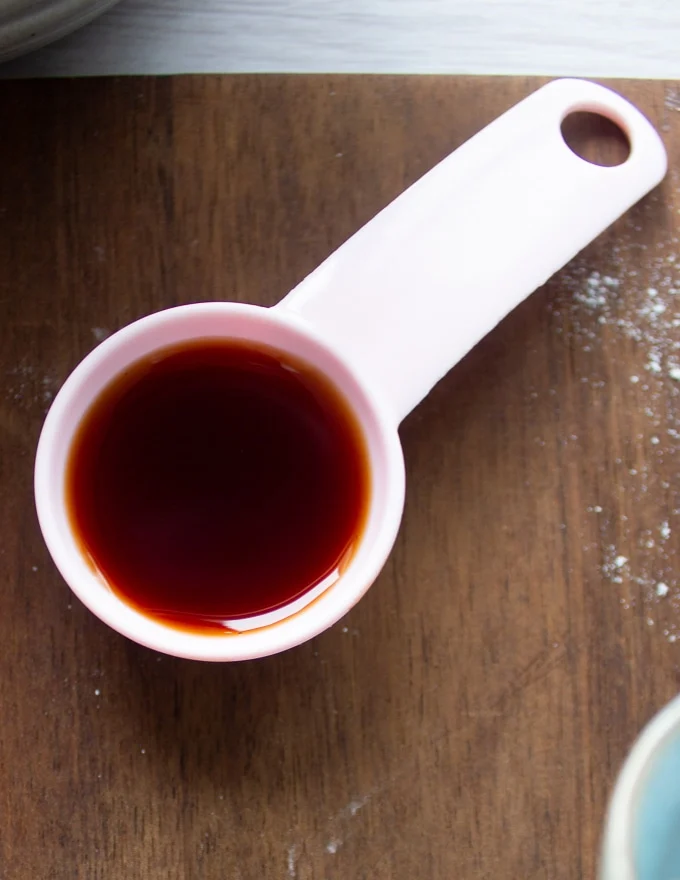 a teaspoon of vanilla on a wooden board