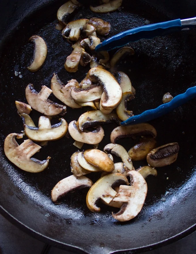 sliced Mushrooms cooking in the same skillet