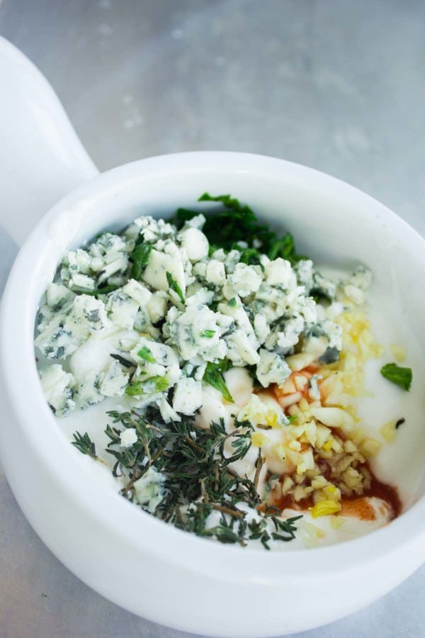 ingredients for Garlic Blue Cheese Dip in a white mortar