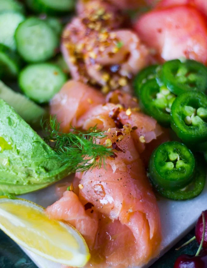 Close up of the smoked curled up and sprinkled with chilli flakes surrounded by jalapeno