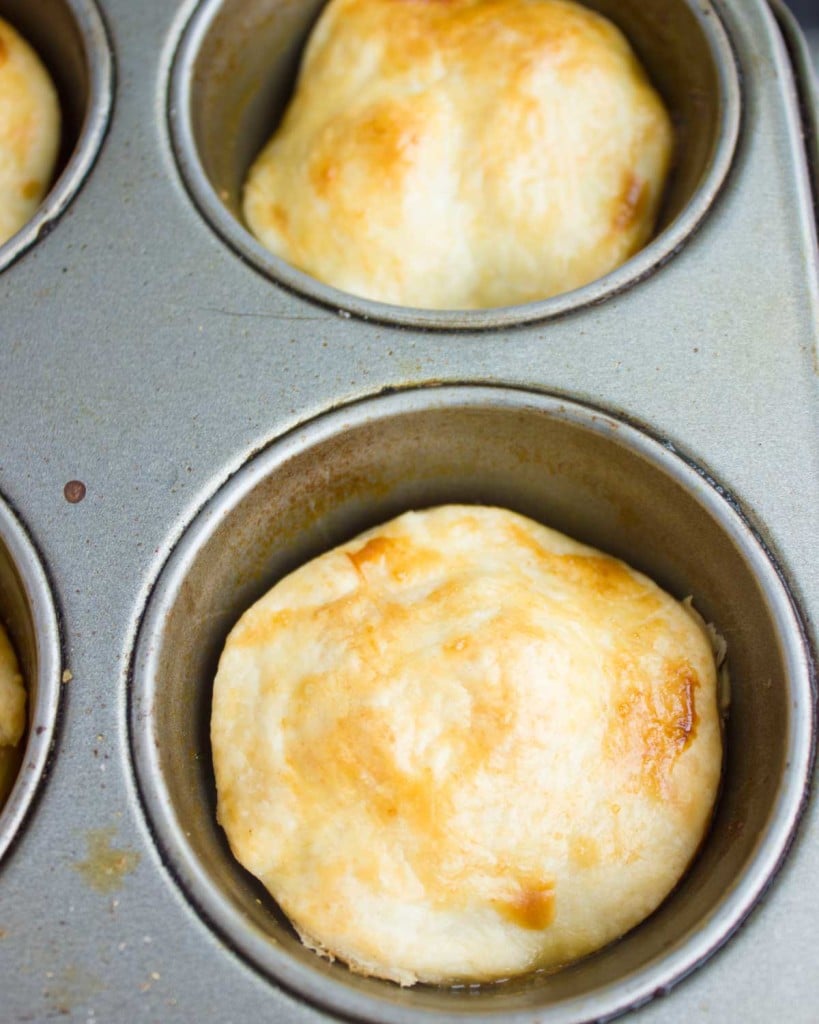 golden brown tomato tarte tatins in a muffin pan before flipping.
