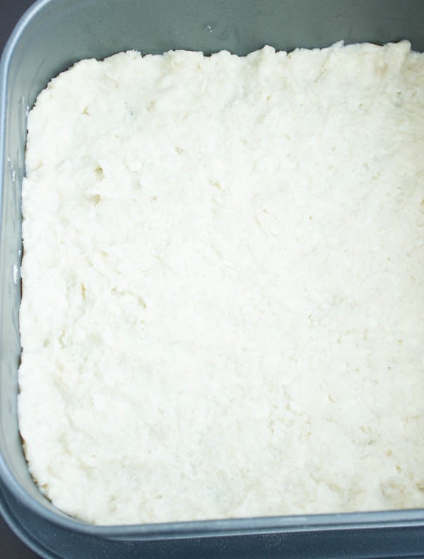 Cookie crust pressed onto baking sheet ready before adding the filling for poppy seed bars