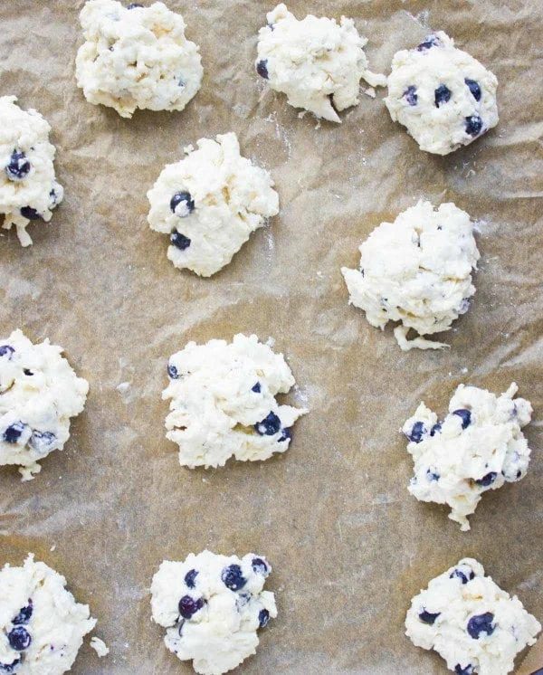 Drop Biscuits on a baking sheet read to bake.