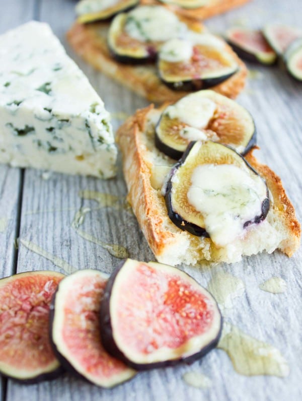 Close-up of Fig Blue Cheese Honey Crostini with one bite taken out the front