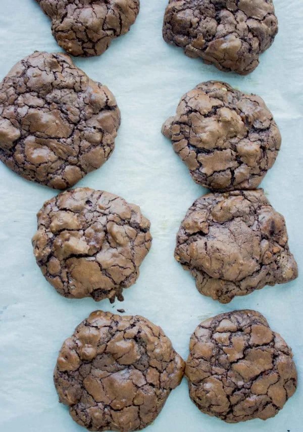 freshly baked chocolate brownie cookies on a baking tray