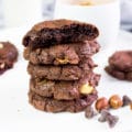 5 Piled up brownie cookies close up and the top one is bitten to show texture
