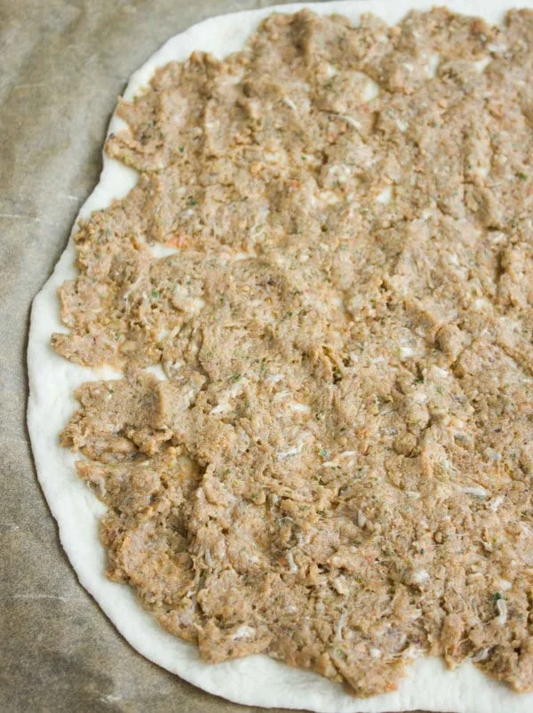 Unbaked Turkish Pizza dough topped with lamb and beef