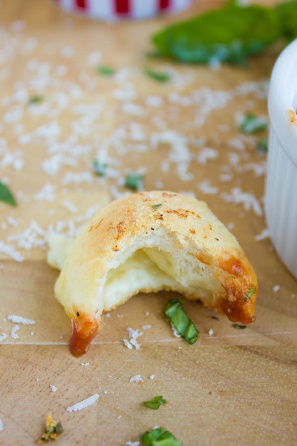Pizza Popcorn Bite with some parmesan cheese and basil sprinkled on top