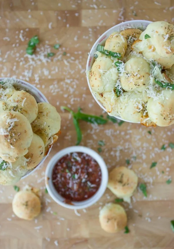 Pizza Popcorn Bites in a popcorn cup with a small dish of pizza sauce for dipping on the side