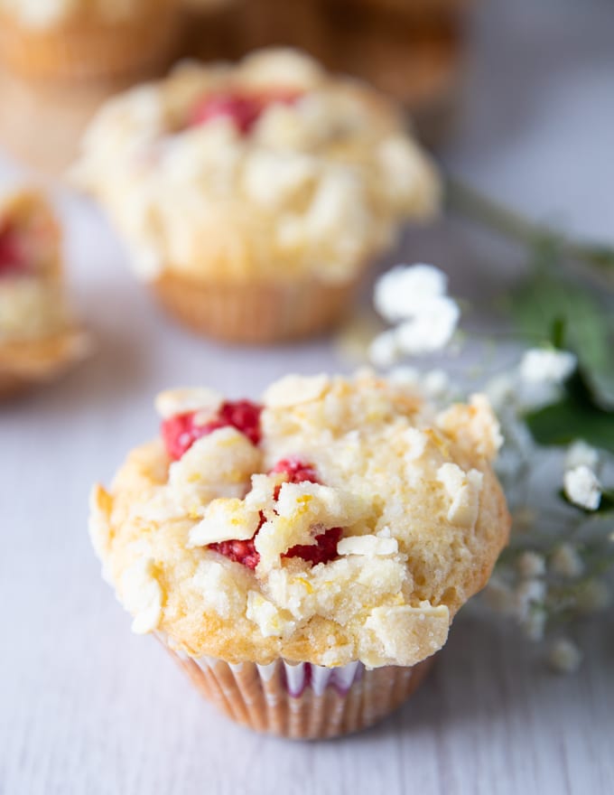 A single raspberry muffin over the white board baked and right out of the oven