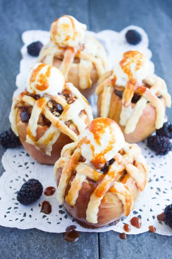 Apple Pie Stuffed Apples with golden brown pie crust lattice and a scoop of caramel drizzled ice cream on top