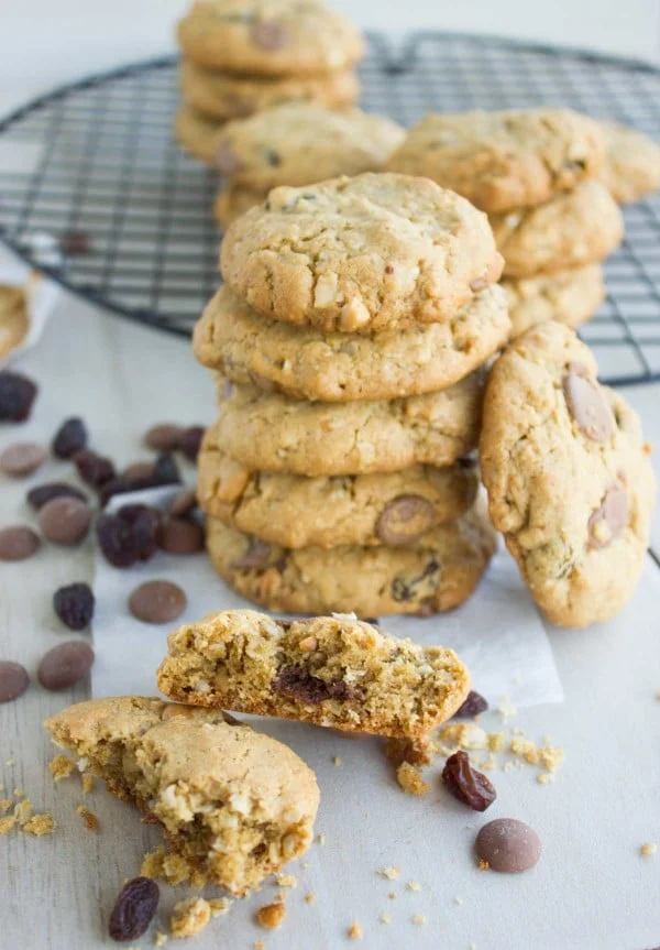 Peanut Butter Chocolate Chip Cookies stacked on top of each other with some chocolate chips scattered between them