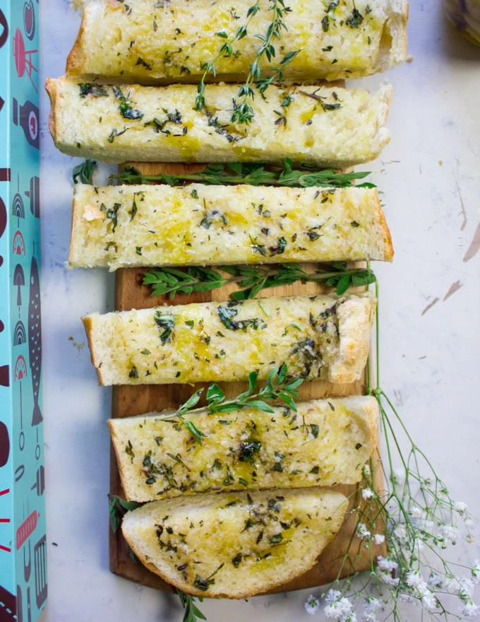 Sliced up garlic bread sticks on a cutting board