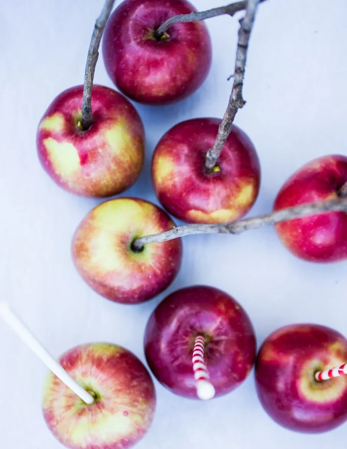 A selection of apples with sick in the center ready for dipping