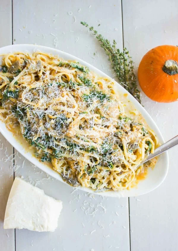 Linguine in Pumpkin Alfredo Sauce with mushrooms and kale on a big pasta plate