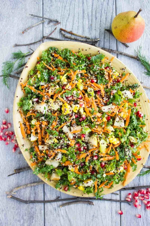 overhead shot of Quinoa Autumn Harvest Salad served in a big wooden bowl placed on a rustic table