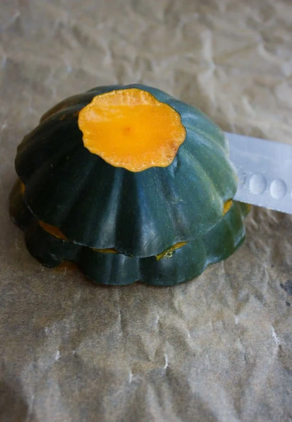 an acorn squash being sliced