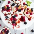 Chocolate Dipped Mini Pavlova. A 5 star delicate dessert shaped into mini hearts, dipped halfway in chocolate, topped with fresh whipped cream, berries and raspberry sauce. Get the recipe with step by step photos and tips to make the PERFECT pavlova every time! foodallianceblog.com
