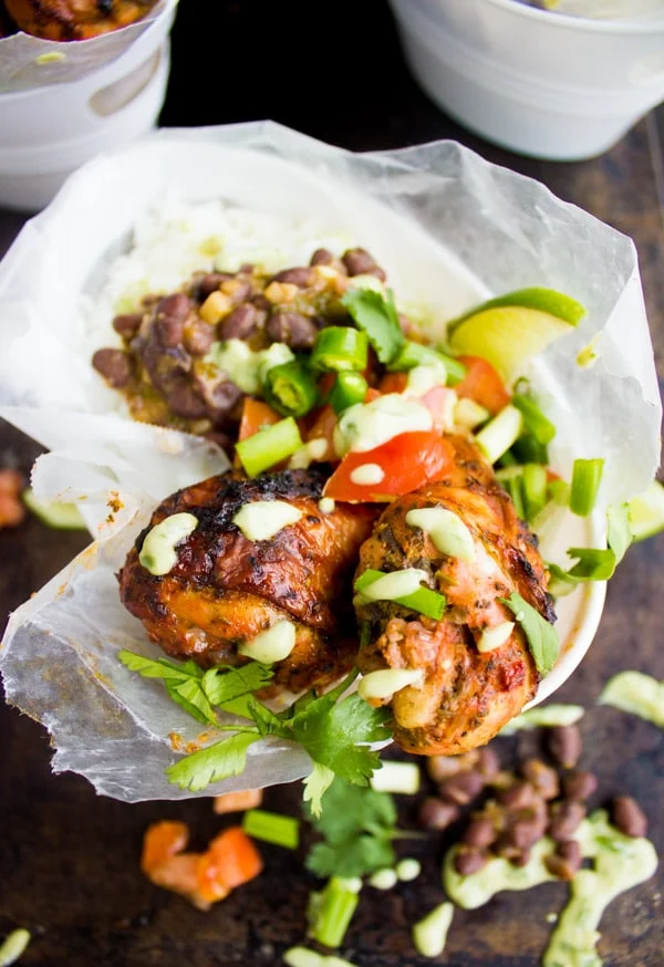 overhead shot of Cuban Black Beans Chicken and Rice with fresh salsa in a take-out dish