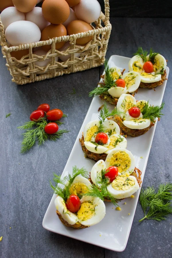 overhead shot of a white rectangular plate with Easter Egg Tart Potato Nests