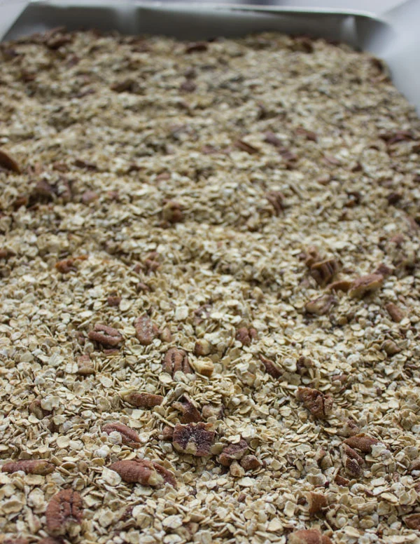 granola spread out on a baking sheet
