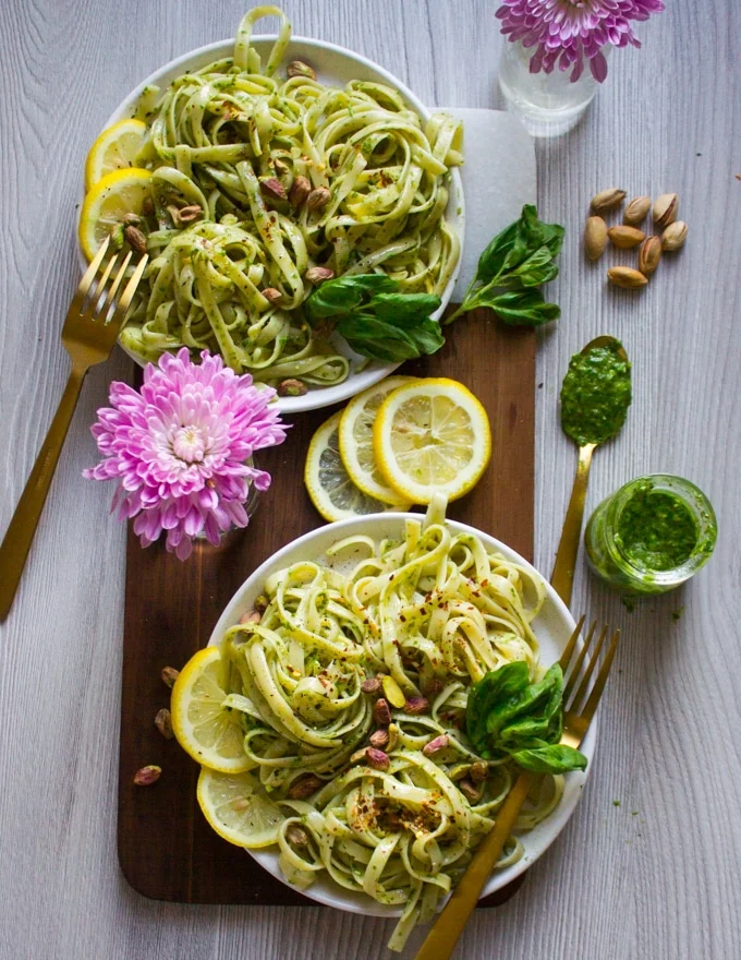Pesto pasta recipe on a plate with a spoonful of sauce, second plate in background