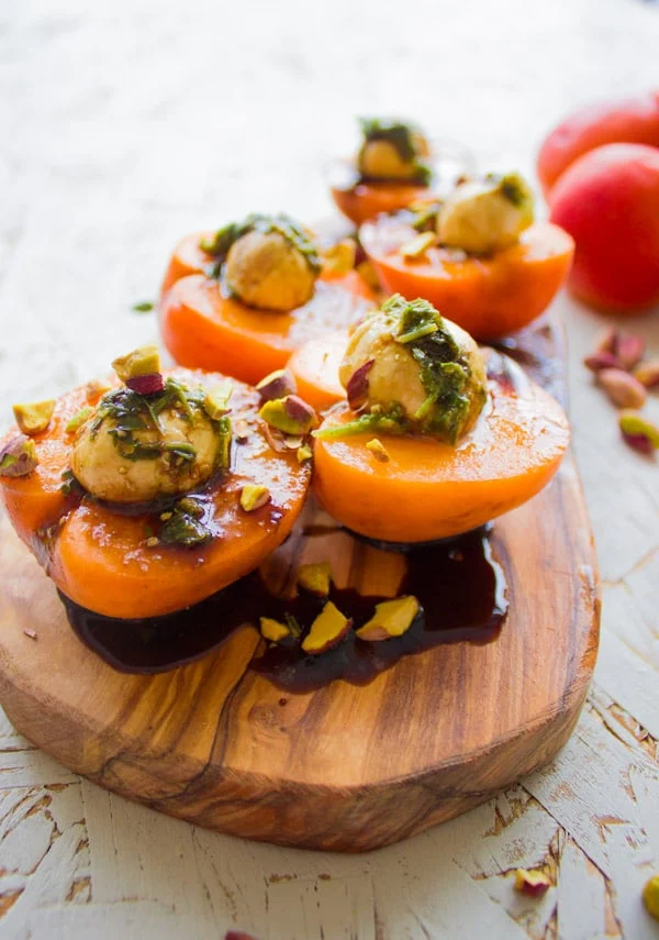 side view of mozzarella stuffed apricots sprinkled with pistachios