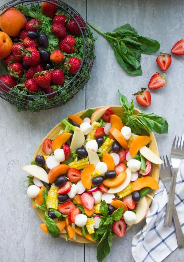 Summer Salad With Fruits & Basil. Swap your veggies, heavy dressings and bring on fruits, corn and some kale for a fresh BBQ salad favorite! Drizzled with a cream Basil Avocado Vegan dressing that you will use on anything and everything--not just the salad! Make this recipe today-foodallianceblog.com