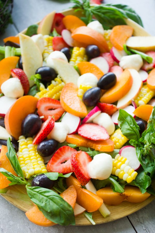 Summer Salad With Fruits & Basil. Swap your veggies, heavy dressings and bring on fruits, corn and some kale for a fresh BBQ salad favorite! Drizzled with a cream Basil Avocado Vegan dressing that you will use on anything and everything--not just the salad! Make this recipe today-foodallianceblog.com