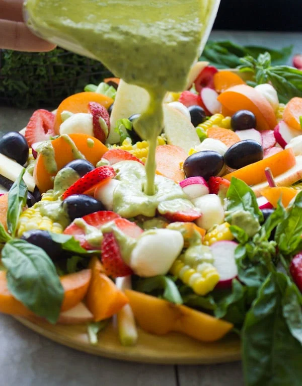 Summer Salad With Fruits & Basil. Swap your veggies, heavy dressings and bring on fruits, corn and some kale for a fresh BBQ salad favorite! Drizzled with a cream Basil Avocado Vegan dressing that you will use on anything and everything--not just the salad! Make this recipe today-foodallianceblog.com