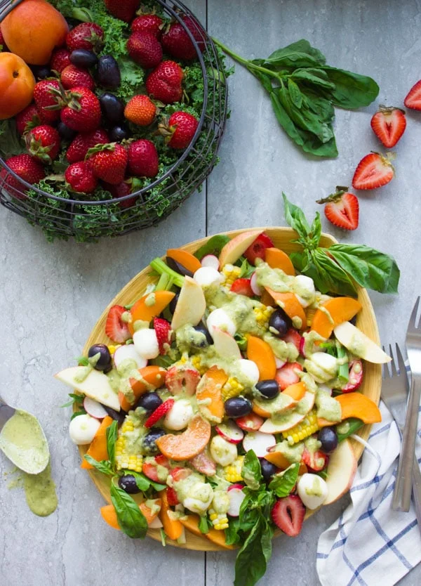 Summer Salad With Fruits & Basil. Swap your veggies, heavy dressings and bring on fruits, corn and some kale for a fresh BBQ salad favorite! Drizzled with a cream Basil Avocado Vegan dressing that you will use on anything and everything--not just the salad! Make this recipe today-foodallianceblog.com