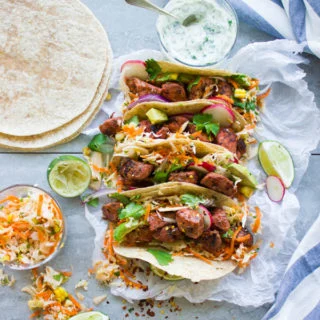 Fiery Tandoori Chicken Tacos with Cilantro Corn Slaw. This is a crazy delicious twist which combines the best of both worlds--succulent tender fiery tandoori chicken pieces on a bed of zesty cilantro corn slaw, topped with radishes, avocados and yogurt sauce, all wrapped in a taco! This recipe is a REAL crowd pleaser in a flash! make it now! foodallianceblog.com