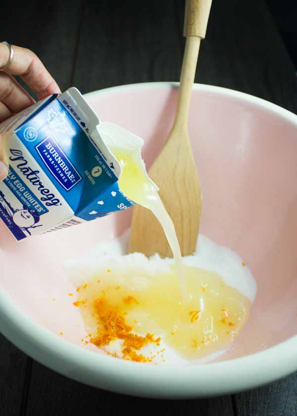 egg white being added to a mixing bowl to make biscotti