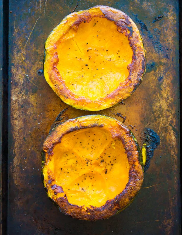 oven roasted halved kabocha squash on a baking sheet