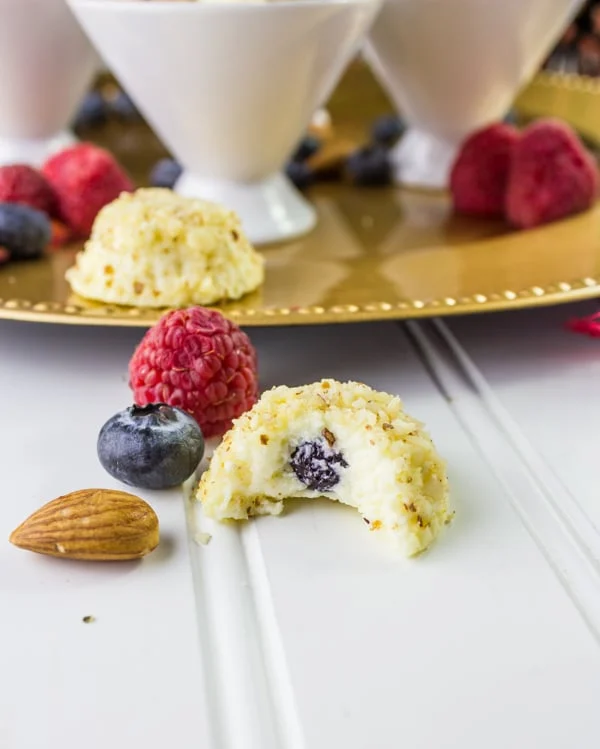 half a Almond Crunch Greek Yogurt Cheesecake Bite revealing a blueberry in the center