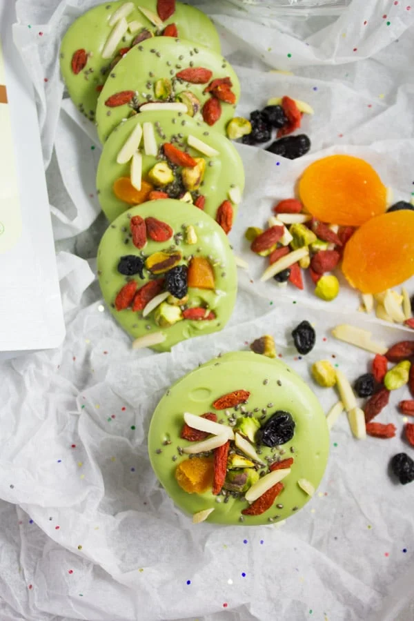 rounds of Matcha Green Tea White Chocolate Bark lined up on white parchment paper