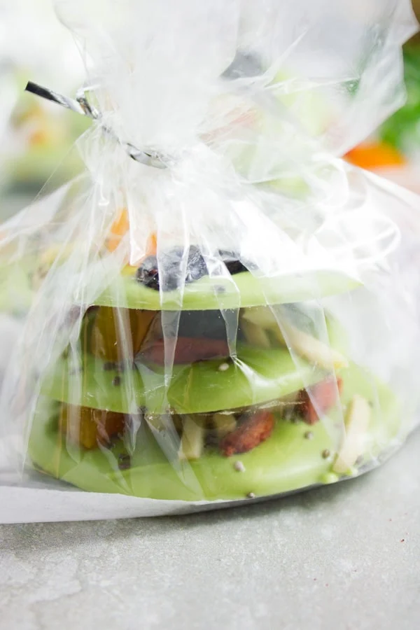 side view of a stack of Matcha Green Tea Chocolate Bark wrapped in transparent giftwrapper
