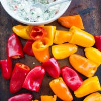 little mini bell peppers next to a bowl with feta filling