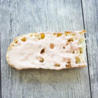 Spicy Sweet Sriracha Ranch Dressing spread on half a ciabatta bun