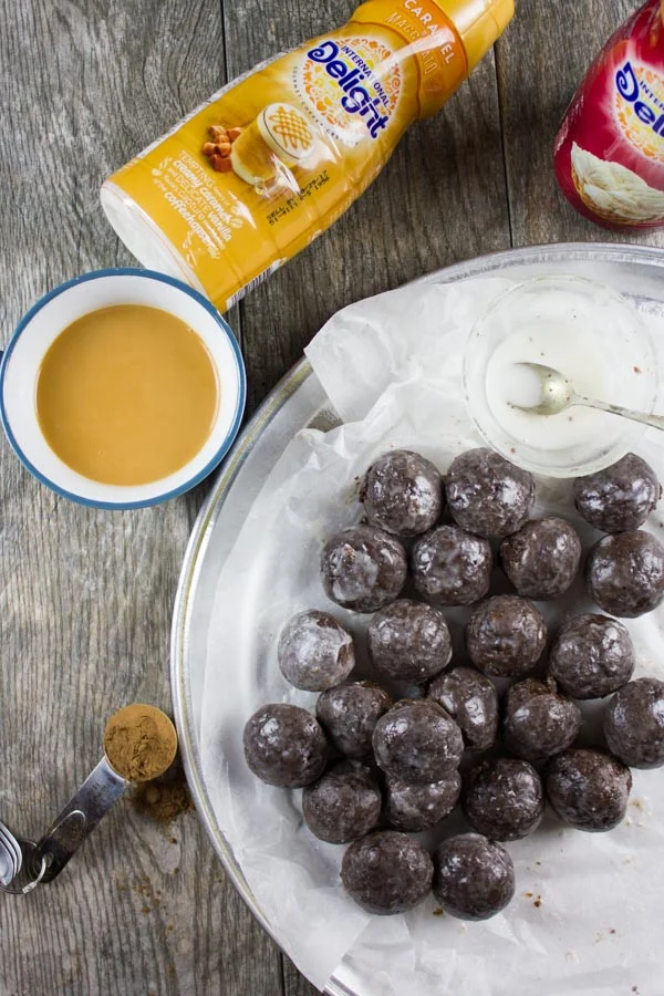 Caramel Spiked Chocolate Donut Holes. The best baked donut holes you'll ever make! tender, fluffy and intensely chocolate-y with a spike of caramel in the donut and glaze! Get the step by step recipe-foodallianceblog.com