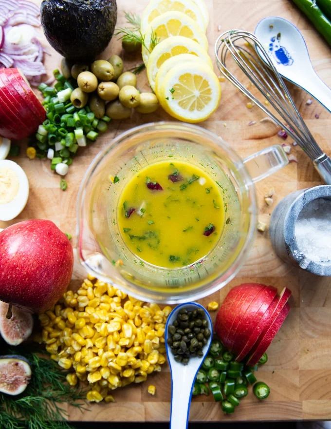 A bowl with the olive oil dressing mixed up and ready to use for tuna salad recipe