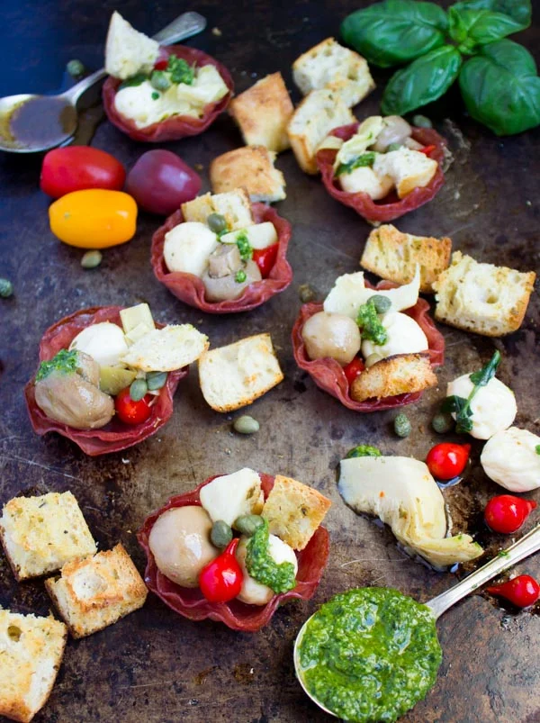 Homemade Salami Cups filled with antipasto arranged on a baking tray