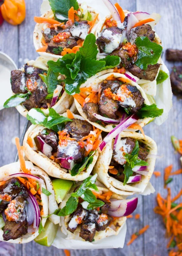 Spicy Harissa lamb shoulder chunks in pita cones with Tahini sauce. A serious Crowd Pleaser that's Loaded with Flavors and a Secret Tip for charring Lamb Chunks I learned form my grandma! Get the recipe and Step by Step at foodallianceblog.com