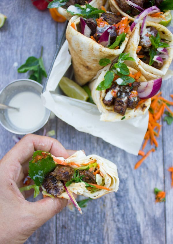 Spicy Harissa lamb shoulder chunks in pita cones with Tahini sauce. A serious Crowd Pleaser that's Loaded with Flavors and a Secret Tip for charring Lamb Chunks I learned form my grandma! Get the recipe and Step by Step at foodallianceblog.com