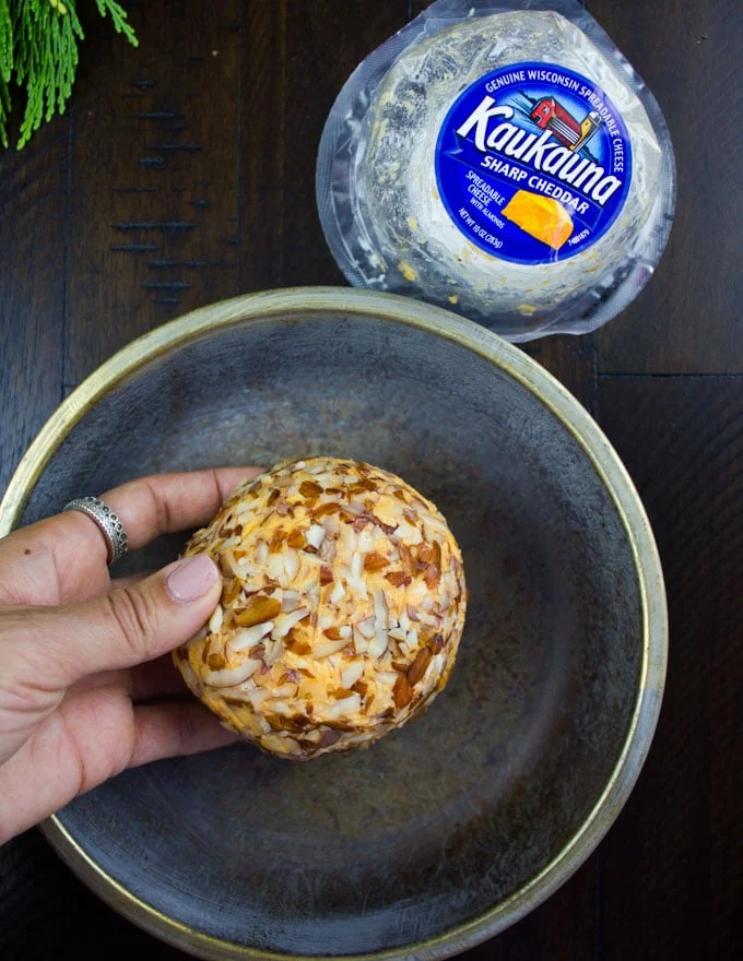 a nut-crusted cheese ball in a bowl