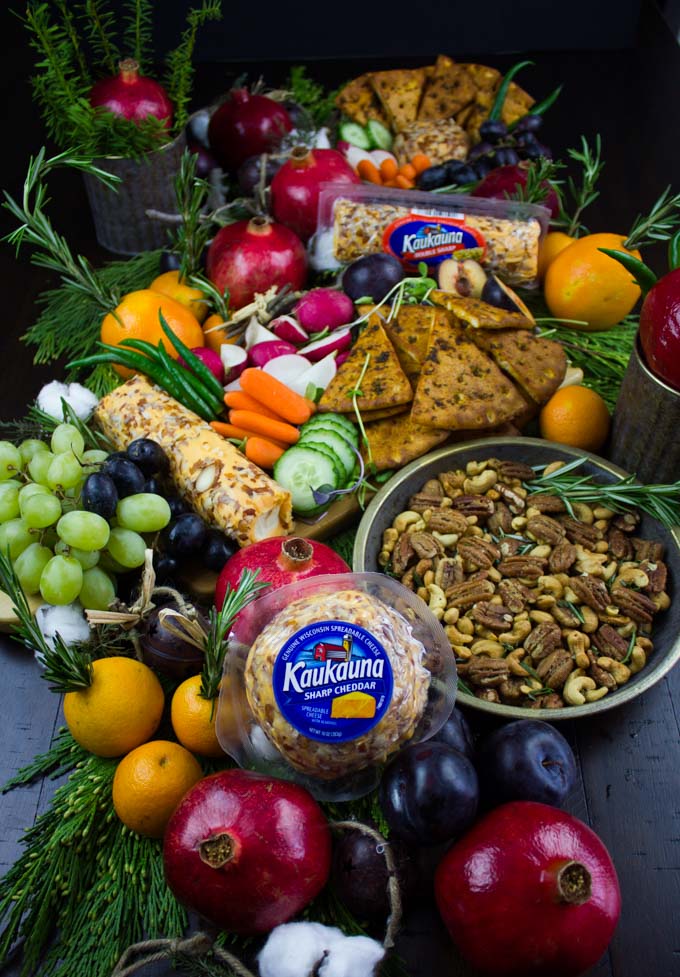 a feast if Rosemary Spiced Candied Pecans and Pita Chips arranged with seasonal fruit for A Cheese Party.