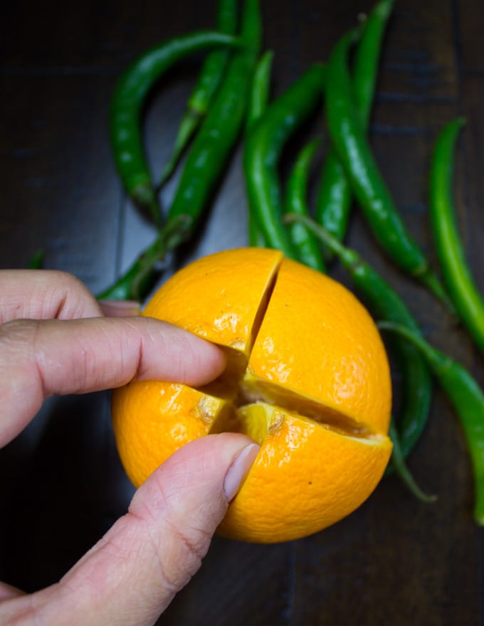 an orange being split open to create a fruit centerpiece