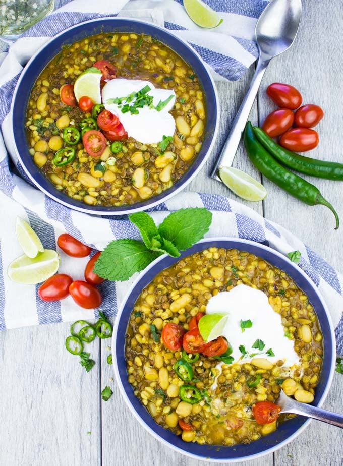 overhead shot of two bowls of Moroccan Lamb and Lentil Soup topped with Greek Yogurt