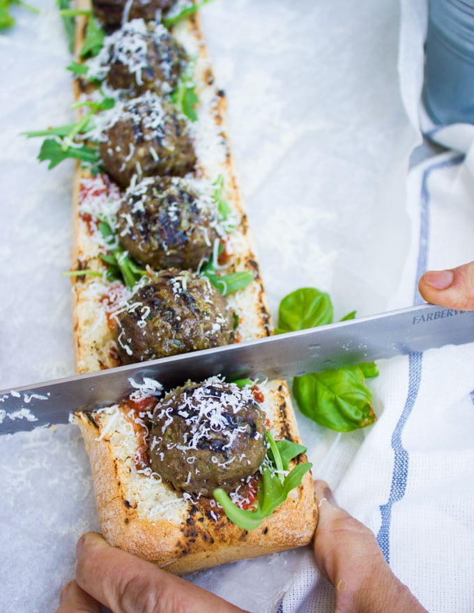 American Lamb Meatball Sub being cut into pieces