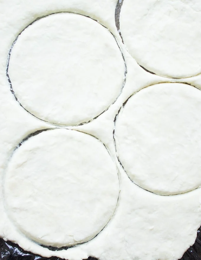 rounds being cut out of pie pastry